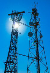 Communication antenna towers on blue sky