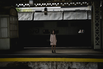 the girl at the station posing in front of a train ride