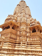 Fototapeta na wymiar Khajuraho is known for its ornate temples that are spectacular piece of human imagination, artistic creativity, magnificent architectural work and deriving spiritual peace through eroticism.