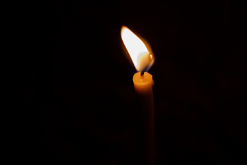 Closeup on Candle light in the dark. Abstract of creative light and hope on dark background 