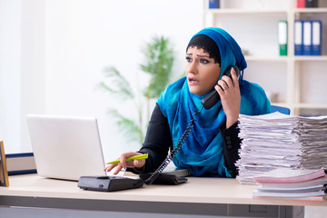 Female employee in hijab working in the office