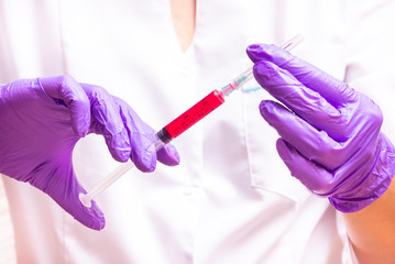 Woman hand holding syringe and ampule