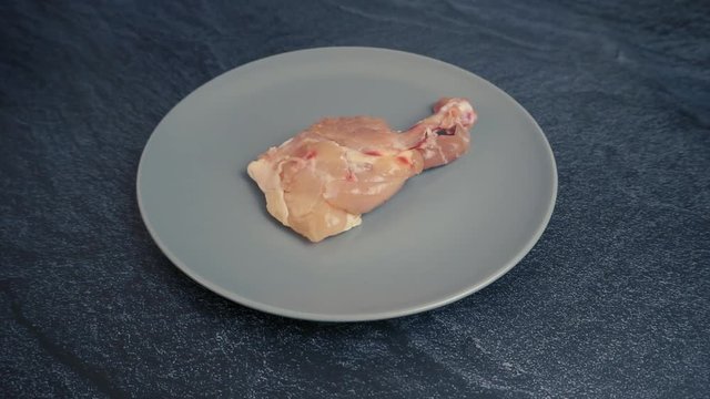Raw chickhen legs on plate