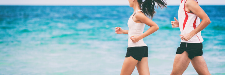Sports athletes runners couple training together jogging on blue ocean background panoramic banner...
