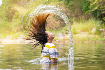 Blurry movement of water hair flip, Fat Asian woman flipping hair in water