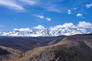 Mountain view with white snowy peaks and blue sky