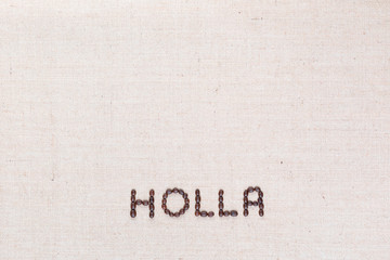 The word Holla written with coffee beans shot from above, aligned at the bottom.