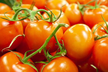 Fresh tomatoes piled on display for sale.