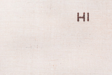 The word Hi written with coffee beans shot from above, aligned at the top right.