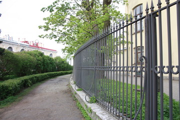 view of the metal fence of the building and trees   
