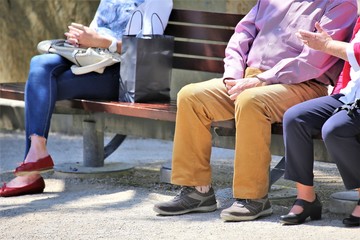 man and woman sitting on bench in the park