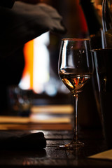 a Glass of wine on the wooden table of the restaurant.