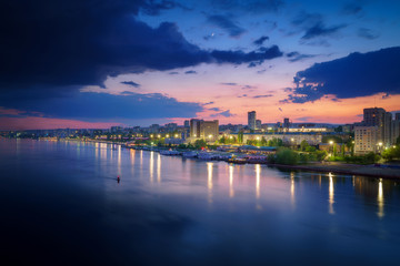 Fototapeta na wymiar Saratov city skyline at sunset, panoramic view to quay from the bridge on Volga river. Russia