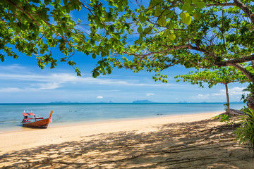 Empty beach with longtail boat on the island of Koh Libong, Thailand