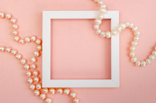 White square frame with pearl beads on a pink pearl design board.
