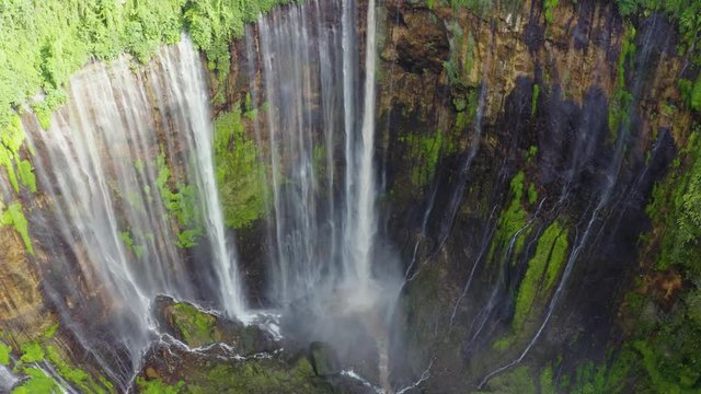 Exotic aerial landscape of Tumpak Sewu waterfall or Coban Sewu in Lumajan, East Java, Indonesia. Shot in 4k resolution from a drone flying forwards