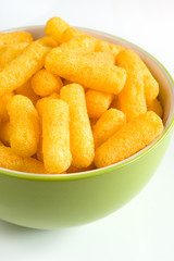 Cheese flavored puffed corn snacks