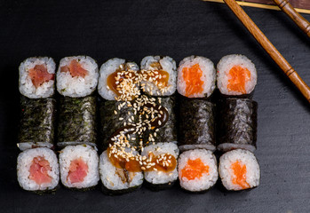 Japanese sushi and rolls on a black background