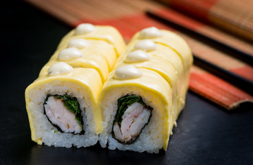 Japanese sushi and rolls on a black background