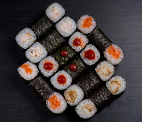 Japanese sushi and rolls on a black background