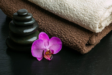 Obraz na płótnie Canvas Zen basalt stones,aromatic candles, bamboo, Aloe Vera and towels. Spa and Wellness concept.