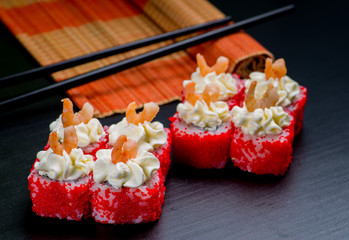 Japanese sushi and rolls on a black background