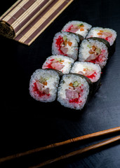 Japanese sushi and rolls on a black background
