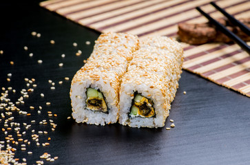 Japanese sushi and rolls on a black background