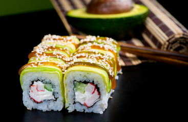 Japanese sushi and rolls on a black background