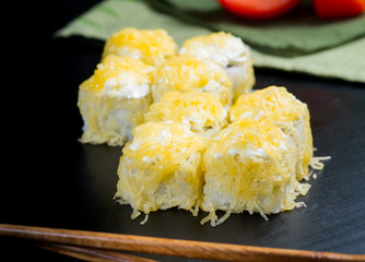 Japanese sushi and rolls on a black background