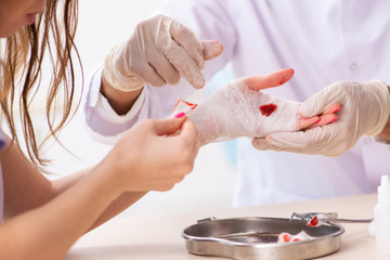Hand injured woman visiting doctor traumatologist 