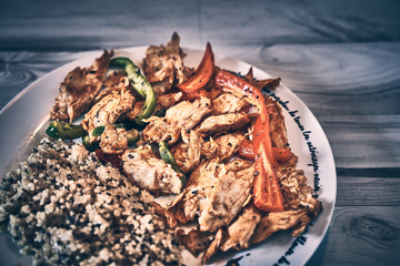 Seitan vegan chicken fillet with quinoa and organic peppers, dark food 