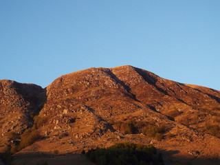 mountains in desert - scotland sunset