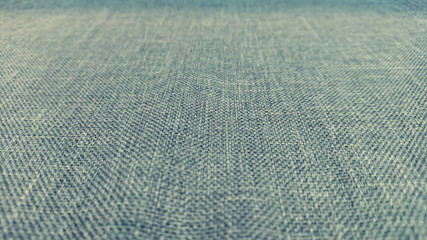 Closeup Shot at The Texture of Cloth / Fabric in Monochrome / Monotone Color for Background, Backdrop, or Wallpaper with Copy Space for Text (Selective Focus).