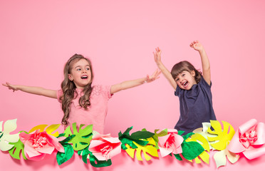 two little girls on summer pink background