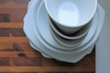 Clean white dishes on brown wooden Board