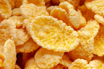 Cornflakes dry breakfast. Yellow flakes texture closeup.