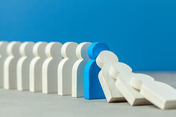 Domino effect in business. One businessman falls and brings down other figures of employees....
