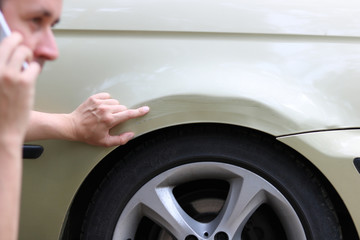 man is calling police after car crash 