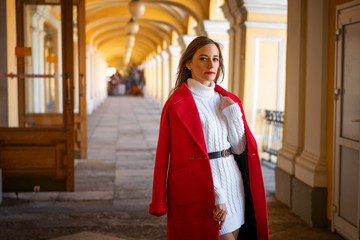 fashion woman in red jacket standing in the street