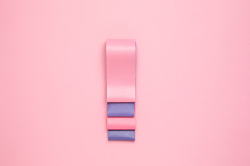 Fitness background. Elastic bands for stretching on a pastel pink background copy space.