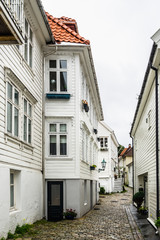 Narrow cozy street with typical wooden houses in Bergen, Norway