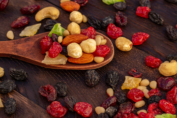 nuts and dried fruits assortment on oak table top view
