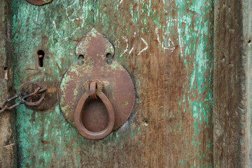 Traditional wooden door in Iran, decorated with metal fittings.