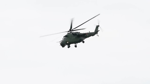 Slow motion fly by of Soviet, Russian gunship helicopter, Mi-24 Hind was used in all major conflicts from Afganistan to Syria. Heavily armed attack helicopter, military concept
