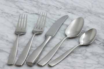 beautiful silverware on carrara marble