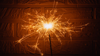 sparkler on white brick wall background
