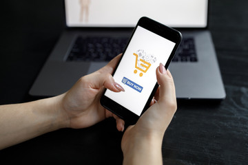 Woman with phone. Online payment. Women hands using smartphone and laptop computer for online shopping. Payment Detail page display.