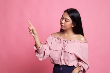 Asian woman touching the screen with  finger.