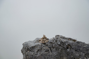 The composition of the stones composed in a pyramid. Misty morning in the mountains.